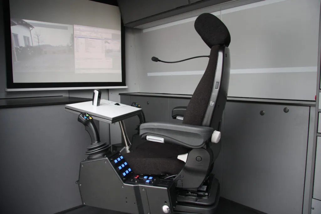 ITV operator station with control console and projection display inside a measurement vehicle